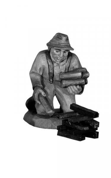 Shepherd kneeling with firewood